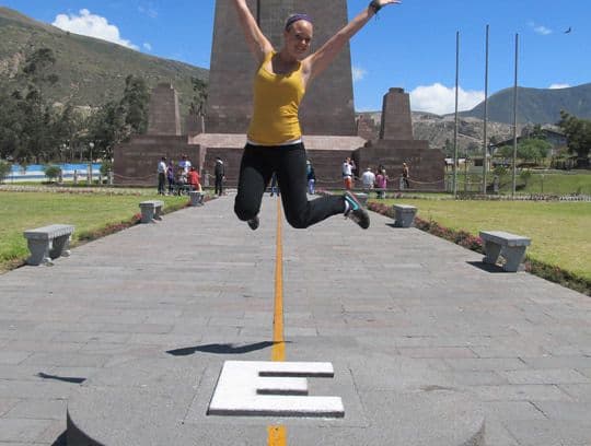 A girl jumps at the equator, in Ecuador.
