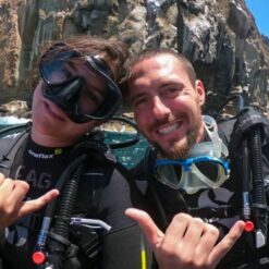 Two divers getting ready to jump in.