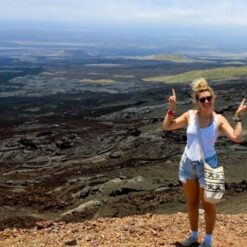 Girl standing on lava flows at Sierra Negra Volcano